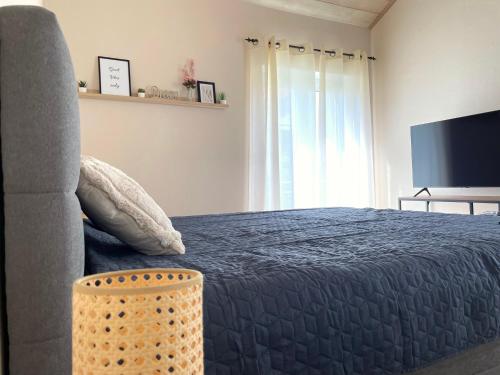 a bedroom with a bed and a television at Exklusives Apartment & Balkon in Unteraichen