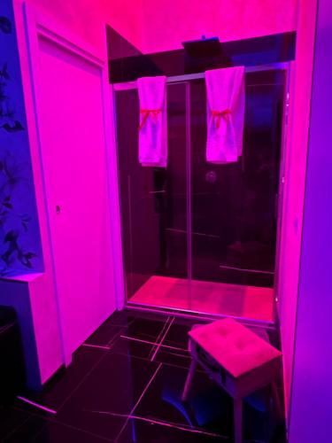 a pink bathroom with a stool and a shower at Lovers in Fiuggi in Fiuggi