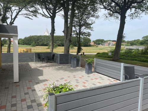 a patio with tables and chairs in a park at Motel Rovli in Skærbæk