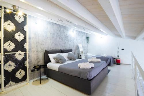 a bedroom with a large bed and a wall at Al Pozzillo casa vacanza SELF CHECK IN in Monreale
