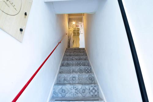 a staircase in a house with a red rope at Pozzillo appartament -near the cathedral in Monreale