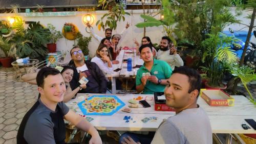 a group of people sitting around a table with a cake at Nextdoor Patan in Pātan