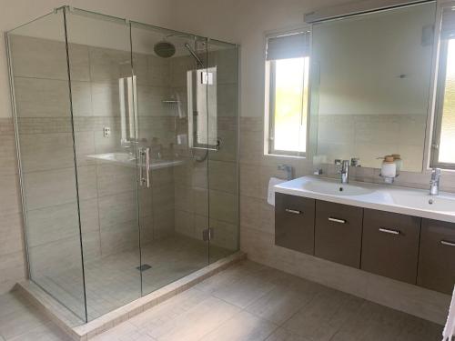 a bathroom with a glass shower and a sink at Brancott Ridge in Renwick
