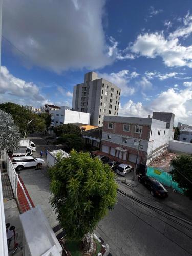 a view of a city with cars parked in a parking lot at Apartahotel y Hotel Sofichic Boutique in Barranquilla