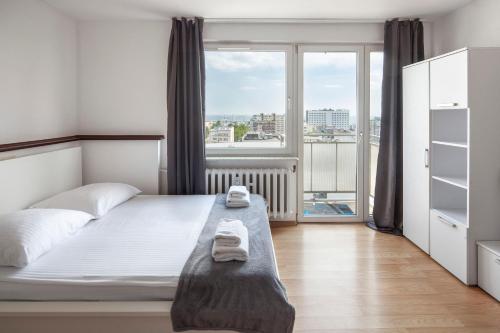 Postel nebo postele na pokoji v ubytování Sleepy3city with Sea View II