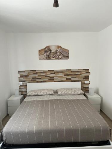 1 dormitorio con 1 cama con pared de ladrillo en Il casale del Nonno Armando en Torrevecchia Teatina