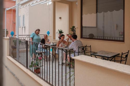 a group of people sitting on a balcony at La Bifora e il granaio in Sciacca
