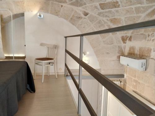 a room with a staircase and a table and a chair at Monolocale prezioso in Trani