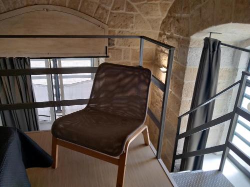 a chair sitting on top of a bunk bed at Monolocale prezioso in Trani