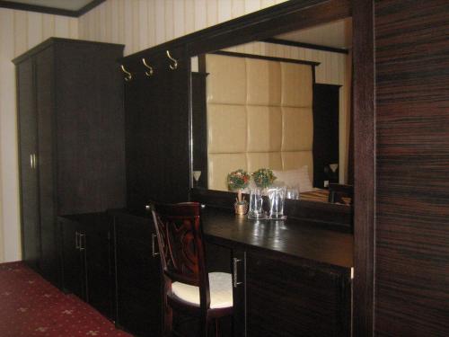 a room with a desk with a large mirror at Hotel Villa Ofir in Sandanski