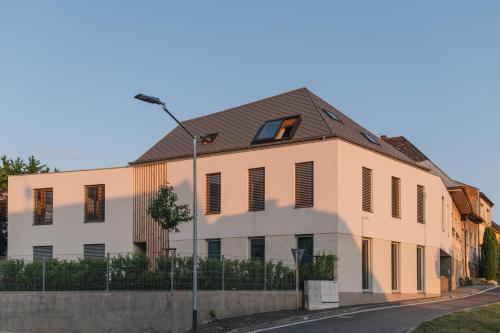 a large white building with a black roof at Apartments Marinka Litomyšl in Litomyšl