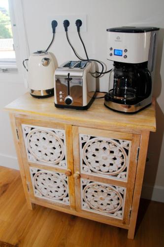 a counter with two coffees and a coffee maker on it at TALABERRI in Bermeo