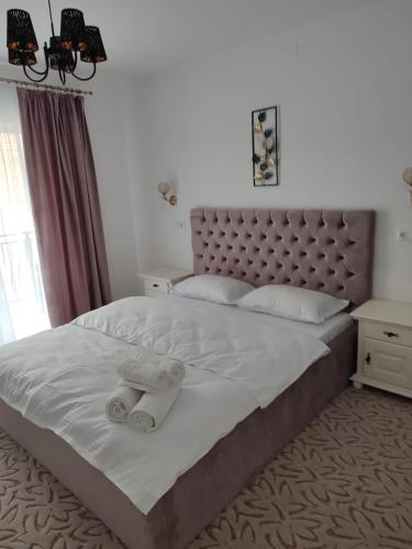 a bedroom with a bed with two towels on it at Casa Anne in Băile Herculane