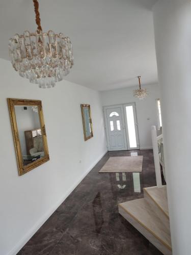 a hallway with a chandelier and a dining room at Casa Anne in Băile Herculane