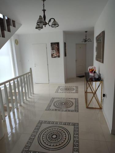 a hallway with a staircase and a room with a rug at Casa Anne in Băile Herculane