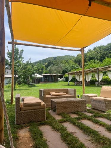 a group of couches and chairs under a tent at Agriturismo Colle Maiano in Vietri sul Mare