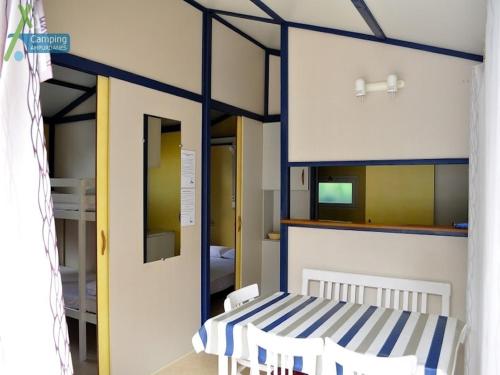 a room with a bed with a blue and white stripes at Camping Ampurdanes in Roses