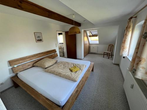 a bedroom with a large bed in a room at Landhaus am Teich in Lohmen