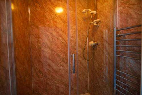 a shower with a glass door in a bathroom at Kipling Villa With Sea Views in Bideford