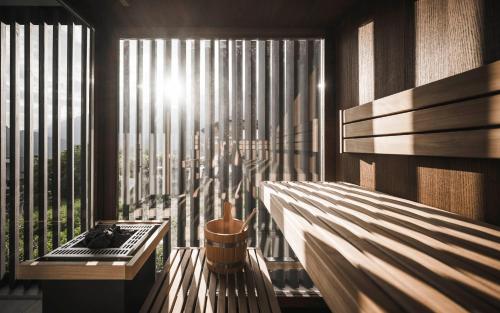 a room with a balcony with a view of a city at SomVita Suites in Tirolo