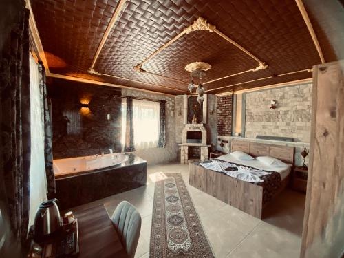 a large bathroom with a tub and a sink at Aysultan Stone House in Uçhisar