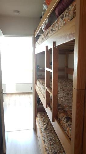 a room with three bunk beds in a room at Charmant studio refait à neuf in La Foux