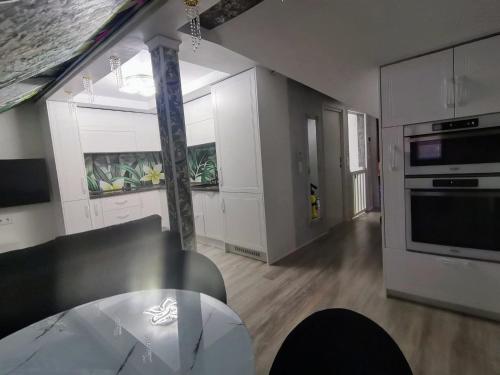 a living room with a table and a kitchen at CezAri ApartHotel in Braşov