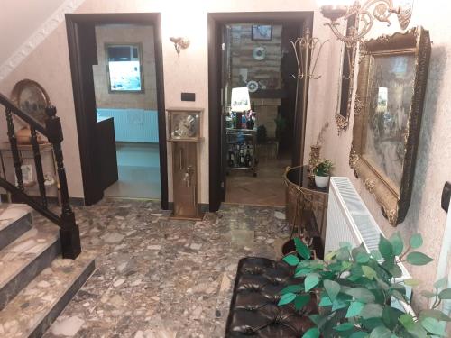 a living room with a couch and a mirror at Hacijenda Vidikovac in Šabac