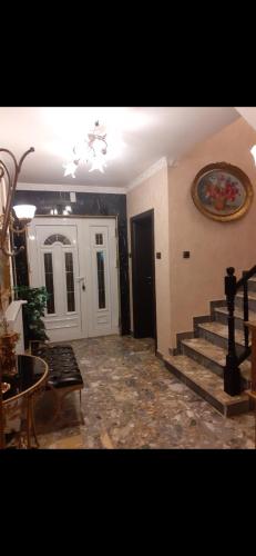 a living room with a staircase in a house at Hacijenda Vidikovac in Šabac