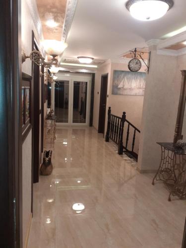 a hallway of a house with a clock on the ceiling at Hacijenda Vidikovac in Šabac