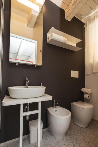 a bathroom with a sink and a toilet at Casa Valentina in Senigallia