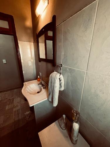 a small bathroom with a sink and a mirror at Don Segundo in Lobos