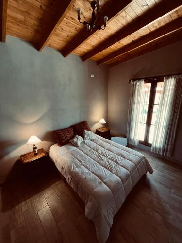 a bedroom with a large bed and two windows at Don Segundo in Lobos