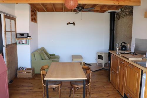 a kitchen and dining room with a table and chairs at Nestudio : studio pour 2 / 3 personnes in Saint-Laurent-de-Neste