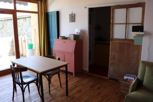 a kitchen with a table and chairs in a room at Nestudio : studio pour 2 / 3 personnes in Saint-Laurent-de-Neste
