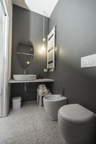 a bathroom with a tub and a toilet and a sink at Casa Valentina in Senigallia