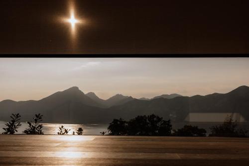 a window with a view of a mountain range at FAVAI HILLS your secret hideaway in Brenzone sul Garda