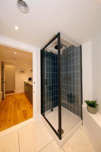 a bathroom with a glass shower in a room at The Artist's House in Scarborough