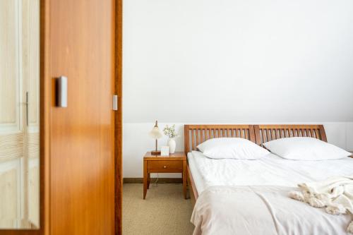 a bedroom with two beds and a wooden door at Willa Bór in Zakopane