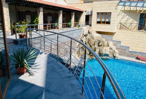 a staircase leading to a swimming pool in a house at Grand Hills in Yerevan