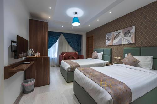 Postel nebo postele na pokoji v ubytování Jasmine Pyramids Hotel