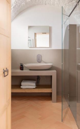 a bathroom with a sink and a mirror at Masseria Auraterrae in Polignano a Mare