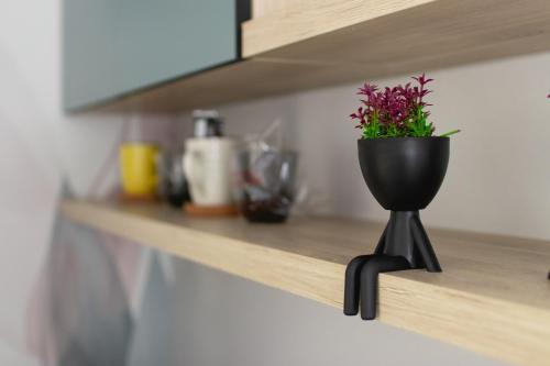 a black flower pot on a shelf in a kitchen at Apartments HAN 2 Sarajevo in Sarajevo