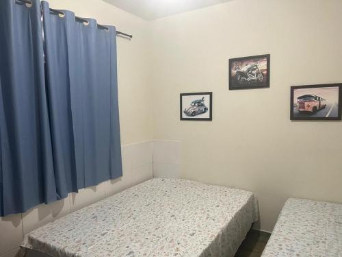 巴拉杜加薩斯的住宿－CASA DE FÉRIAS II，一间卧室配有两张床和蓝色窗帘