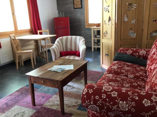 a living room with a couch and a table at Chalet le Knou in Champéry