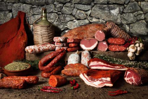 a bunch of meats and vegetables on a table at Casa vacanze da CLARA in Castrovillari
