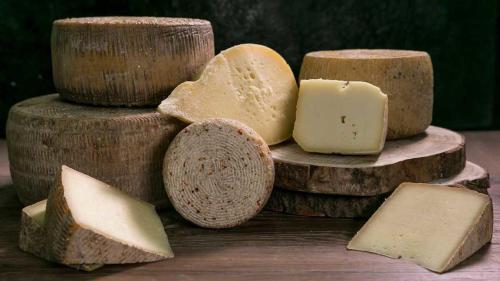 a pile of different types of cheese on a table at Casa vacanze da CLARA in Castrovillari