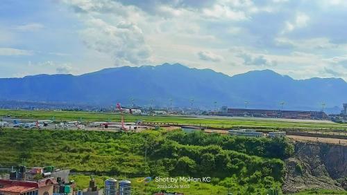 a view of an airport with mountains in the background at Kathmandu Airport View Hotel And Lodge in Kathmandu