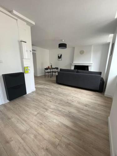 a living room with a couch and a table at Appartement1 neuf climatisée in Blaye