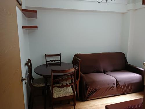 a living room with a couch and a table at Apartamento Patiño en Marín in Marín